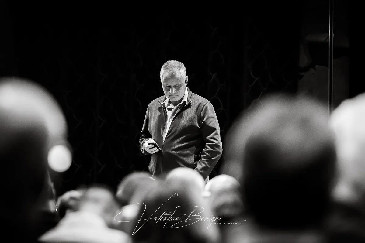 a man standing in front of a crowd for a corporate event